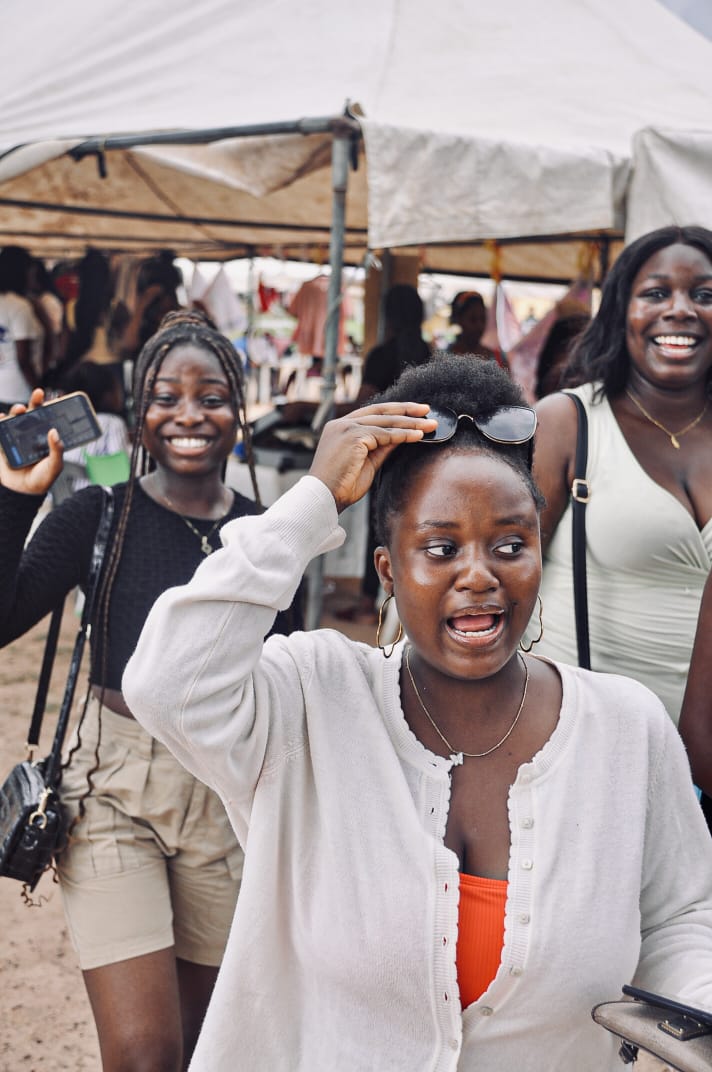 A guest laughing joyfully under the festival tents